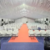 Marquee stage seating with red carpet aisle