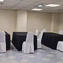 Meeting room tables with black covers and white chair covers
