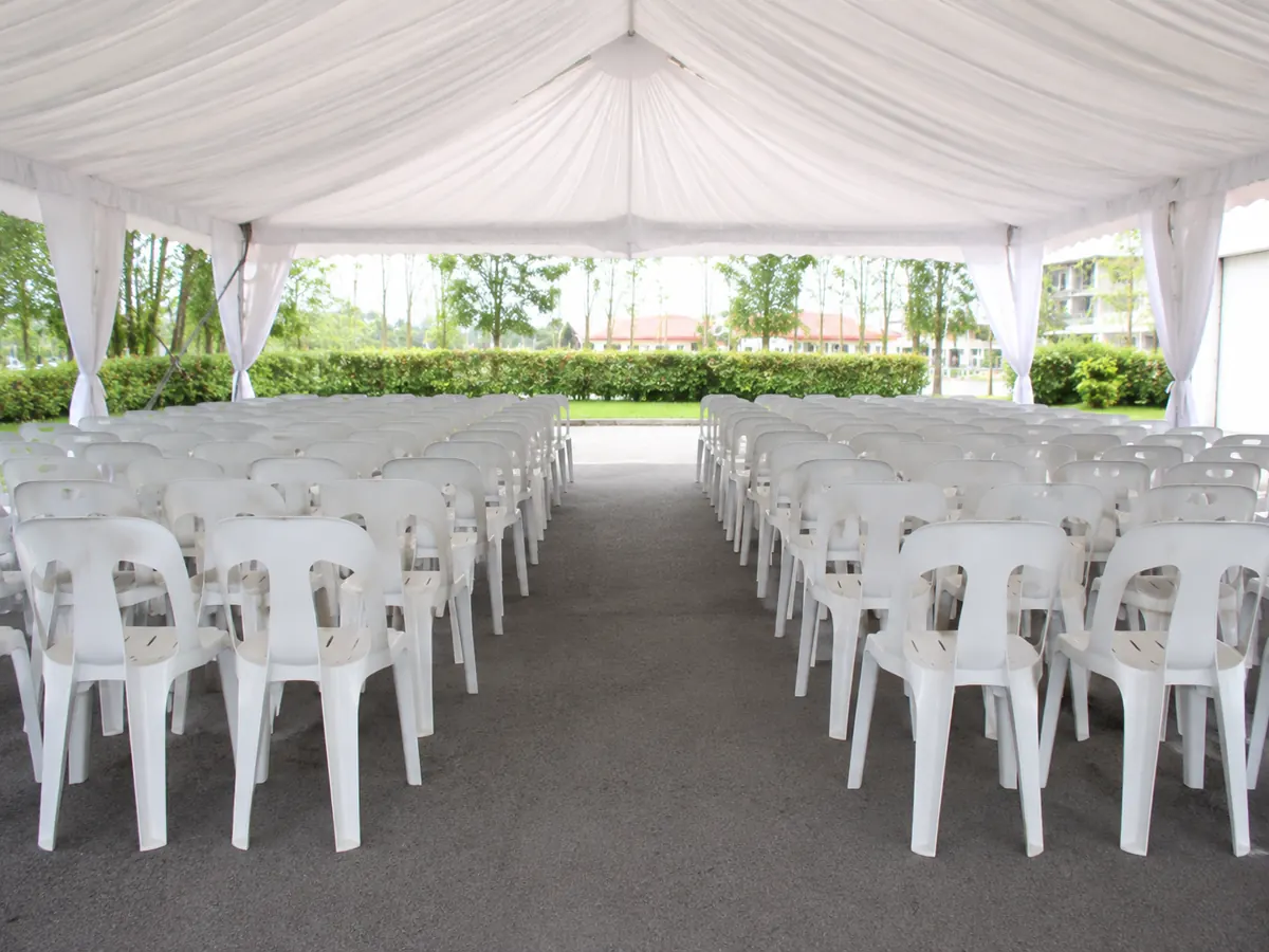 White plastic chairs arranged under a canopy for outdoor seating