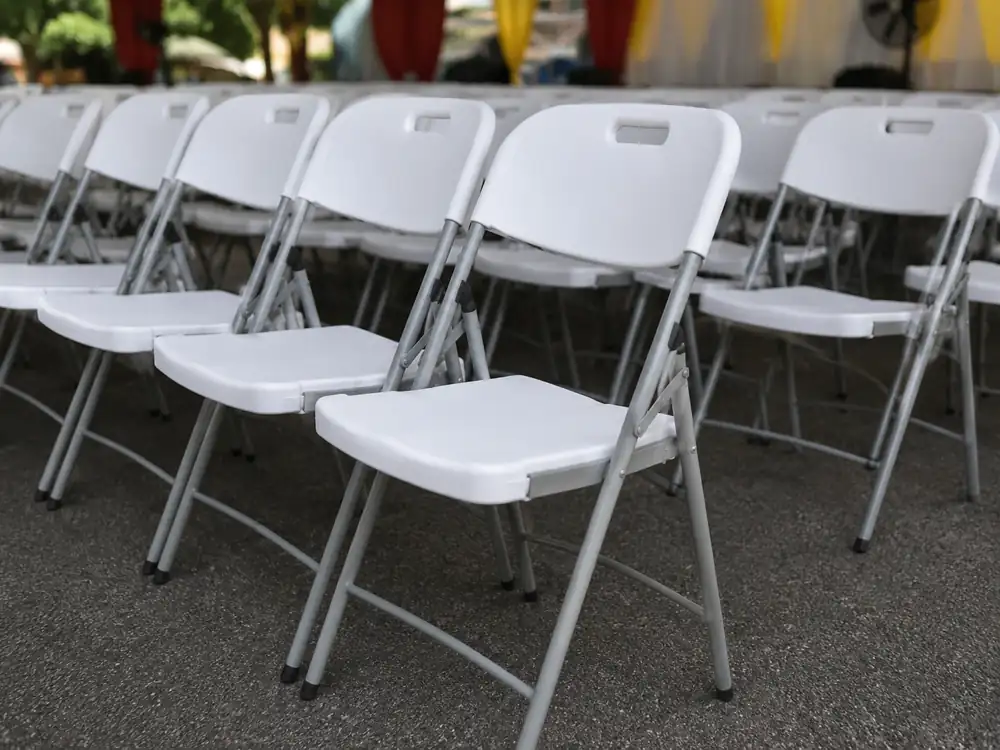 White plastic folding chairs close up for event seating